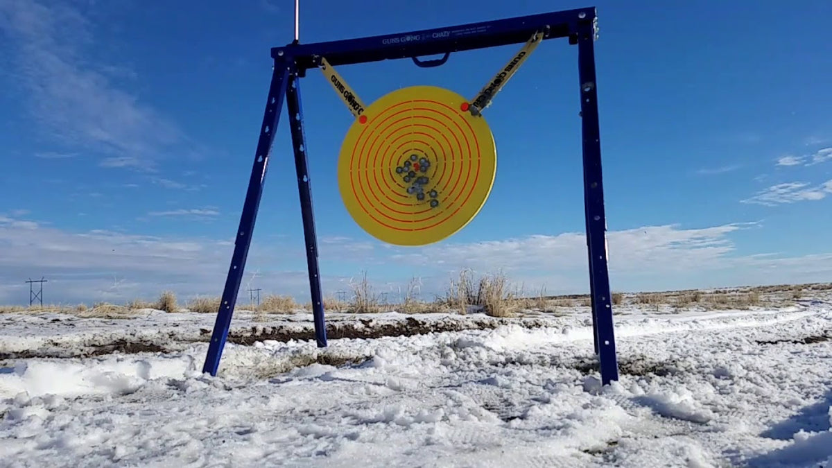 Guns Gong Crazy portable AR500 steel gong target system in use at outdoor shooting range